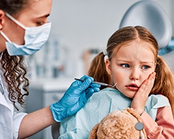 A young girl about to get emergency dental care