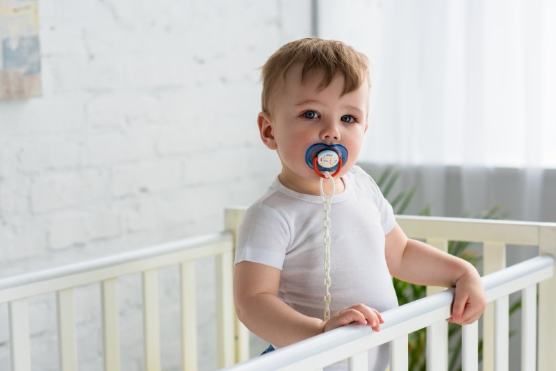 A baby sucking a pacifier