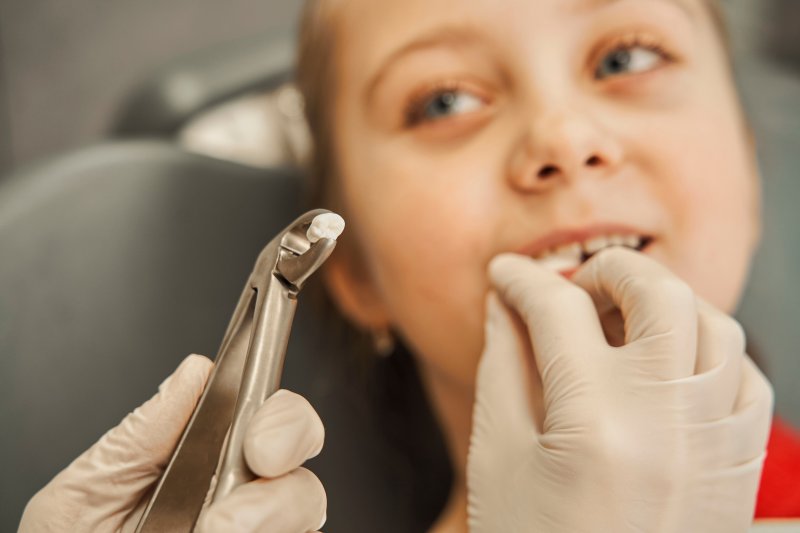 Young child having tooth extracted.
