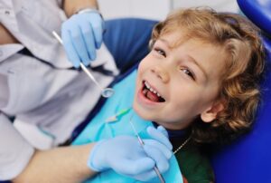 Child smiling while at his pediatric dentist